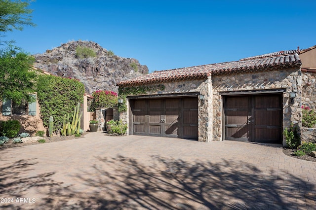 garage featuring driveway and a mountain view