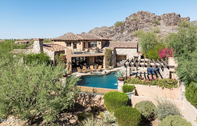 view of swimming pool featuring a patio area and a mountain view