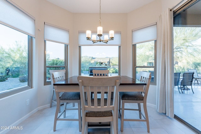 tiled dining room with a chandelier