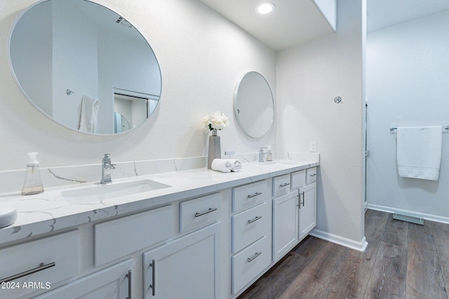 bathroom with vanity and wood-type flooring