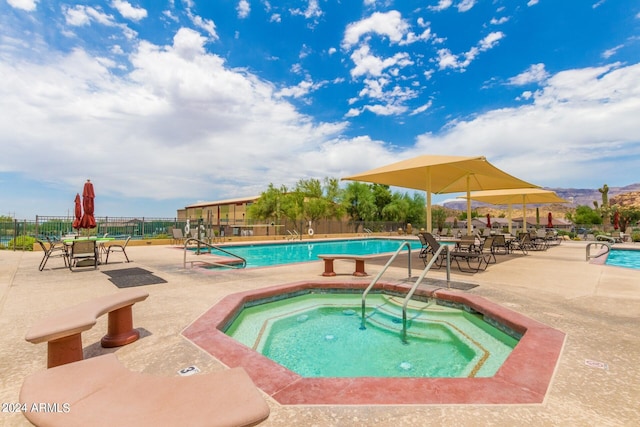 view of pool featuring a hot tub and a patio