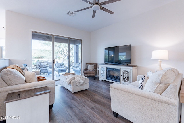 living room featuring a fireplace, dark hardwood / wood-style floors, and ceiling fan