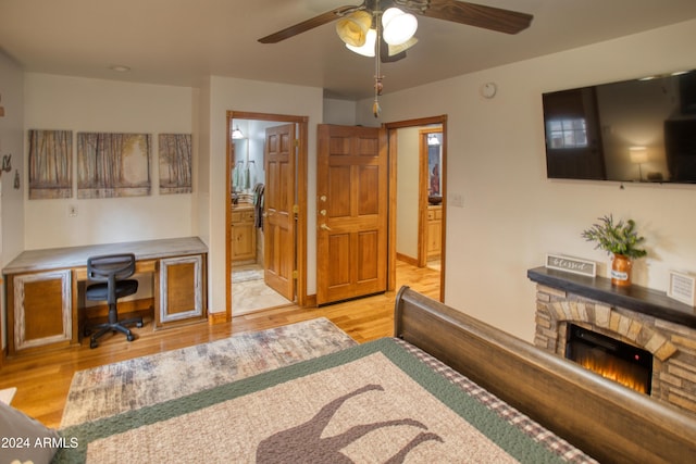 interior space featuring ceiling fan, light hardwood / wood-style floors, and a fireplace