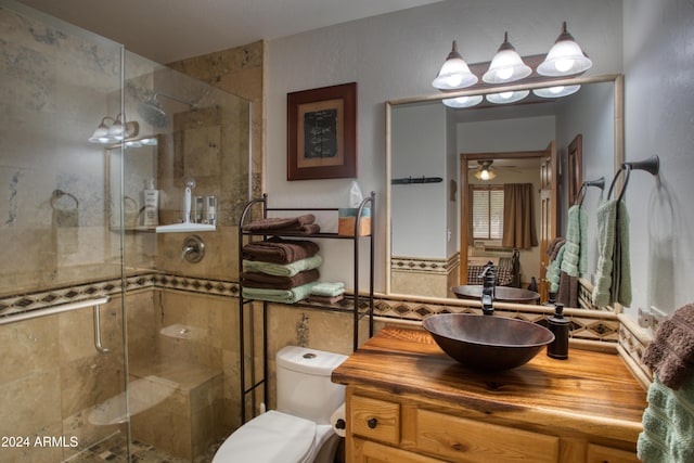 bathroom with a chandelier, vanity, toilet, and walk in shower