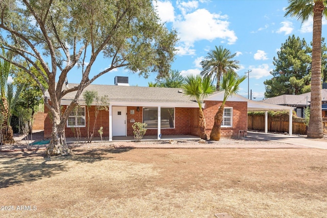 1238 E Cambridge Ave, Phoenix, AZ 85006 - ranch-style home with brick siding, an attached carport, driveway, and a porch