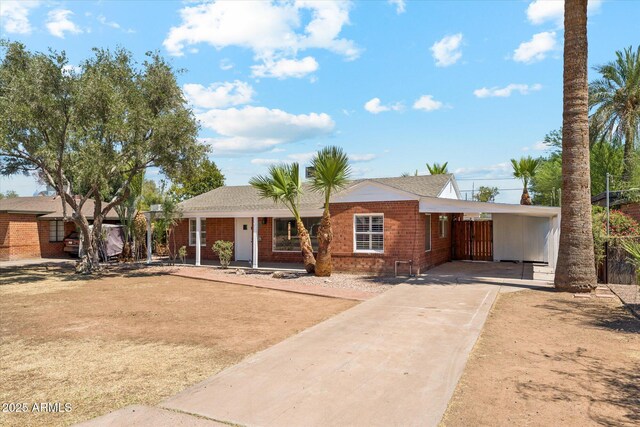 1238 E Cambridge Ave, Phoenix, AZ 85006 - ranch-style house with concrete driveway, brick siding, and a carport