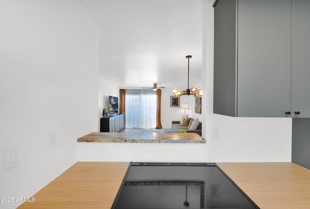 4600 N 68th St Unit 370, Scottsdale, AZ 85251 - kitchen with light countertops, a chandelier, and cooktop