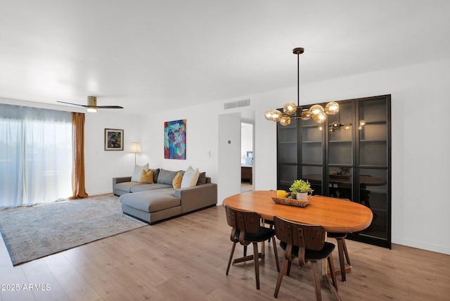 4600 N 68th St Unit 370, Scottsdale, AZ 85251 - dining room featuring wood finished floors, a chandelier, baseboards, and ceiling fan