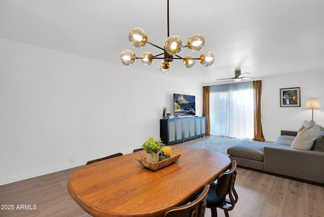 4600 N 68th St Unit 370, Scottsdale, AZ 85251 - dining area featuring a chandelier, wood finished floors, ceiling fan, and baseboards