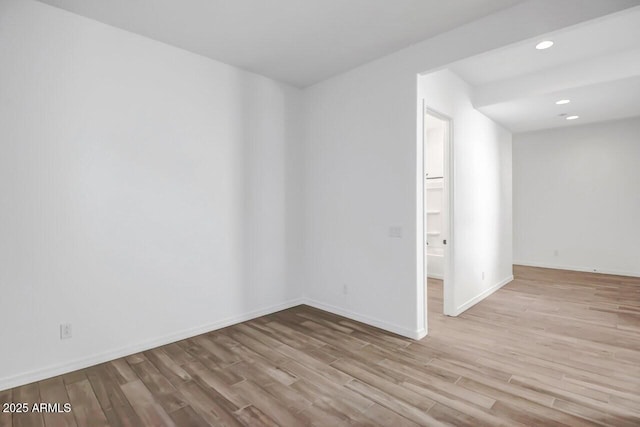 unfurnished room with recessed lighting, baseboards, and wood finished floors