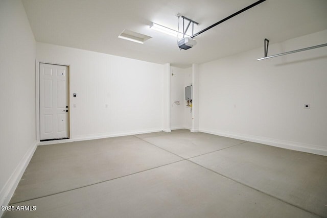 garage with electric panel, a garage door opener, and baseboards