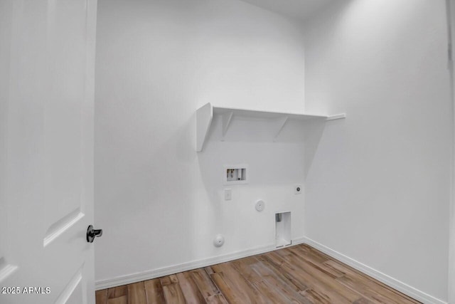 clothes washing area featuring hookup for a washing machine, wood finished floors, hookup for an electric dryer, laundry area, and hookup for a gas dryer