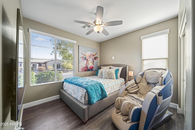 bedroom with dark hardwood / wood-style floors and ceiling fan