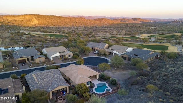 aerial view at dusk featuring a mountain view