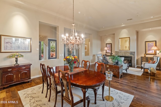 dining room with dark hardwood / wood-style floors, a notable chandelier, and ornamental molding