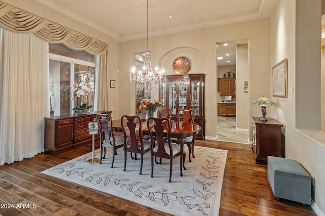 dining space featuring dark hardwood / wood-style floors and an inviting chandelier