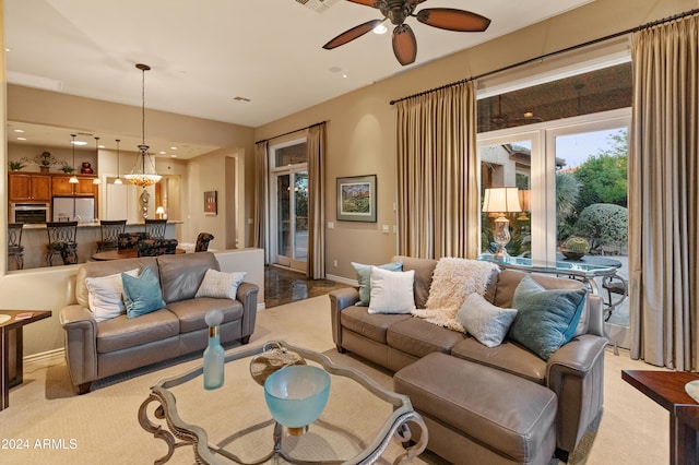 living room featuring light colored carpet and ceiling fan