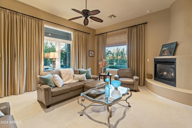 carpeted living room with ceiling fan