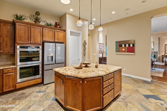 kitchen with tasteful backsplash, stainless steel appliances, a kitchen island, decorative light fixtures, and light stone countertops