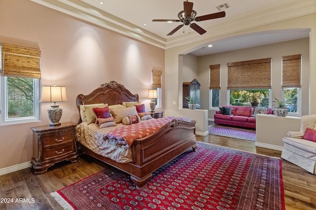 bedroom with ceiling fan, crown molding, and wood-type flooring