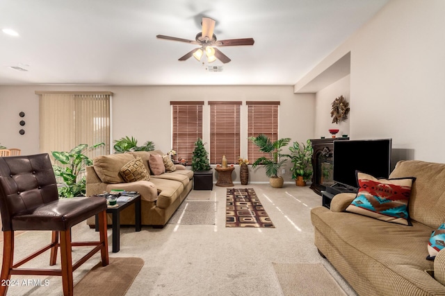 carpeted living room featuring ceiling fan