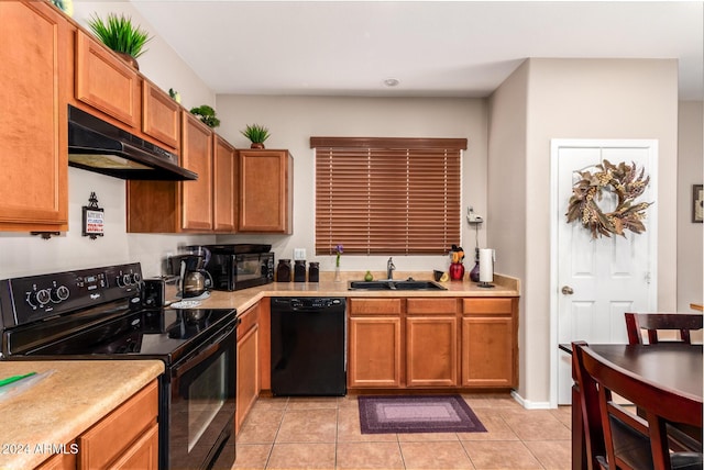 kitchen with black appliances, light tile patterned flooring, and sink