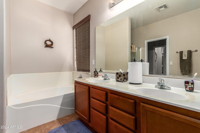 bathroom with vanity, tile patterned floors, and a tub