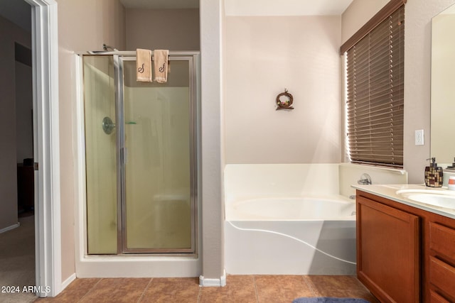 bathroom featuring vanity, tile patterned flooring, and plus walk in shower