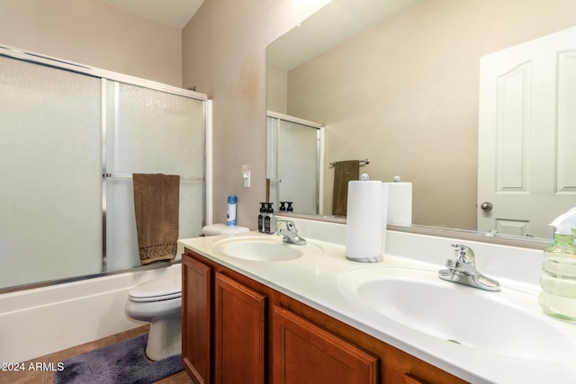 full bathroom with toilet, vanity, and combined bath / shower with glass door