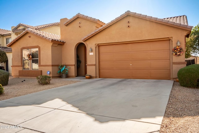 mediterranean / spanish house featuring a garage