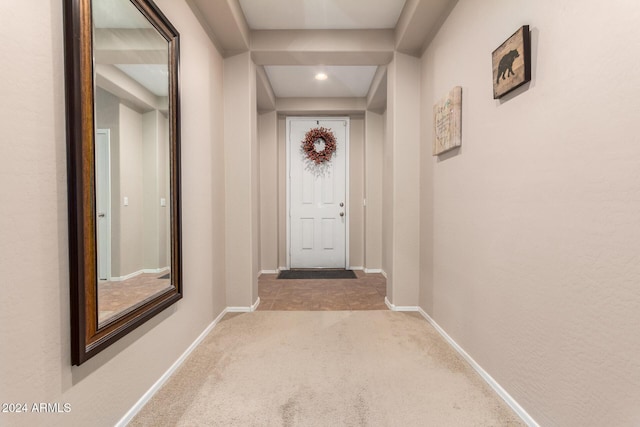 entryway featuring light carpet