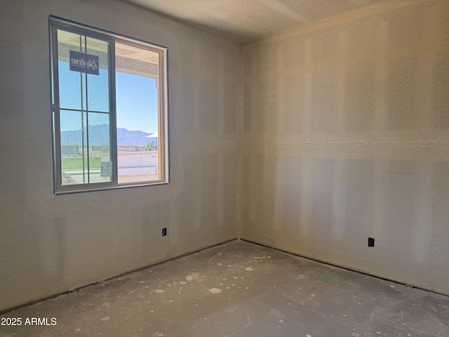 spare room featuring a mountain view