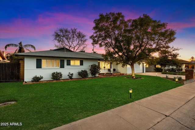 view of front of house with a garage and a lawn