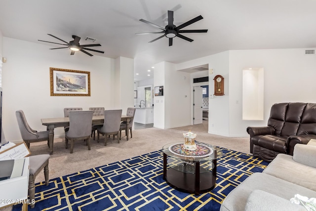 carpeted living room with sink