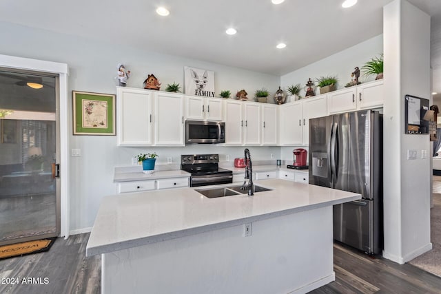 kitchen with dark wood-type flooring, sink, an island with sink, and stainless steel appliances