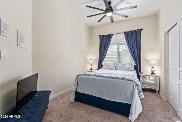 carpeted bedroom with ceiling fan and a closet