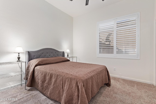 carpeted bedroom with ceiling fan and lofted ceiling