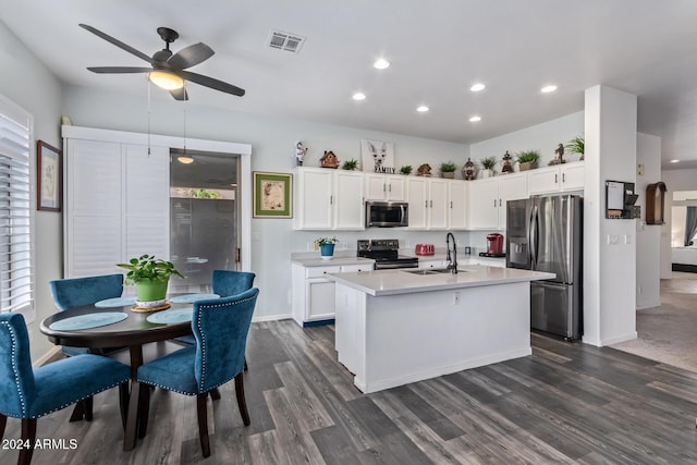 kitchen with ceiling fan, sink, an island with sink, white cabinets, and appliances with stainless steel finishes