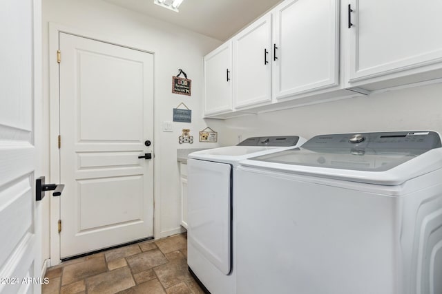 laundry area with washing machine and dryer and cabinets