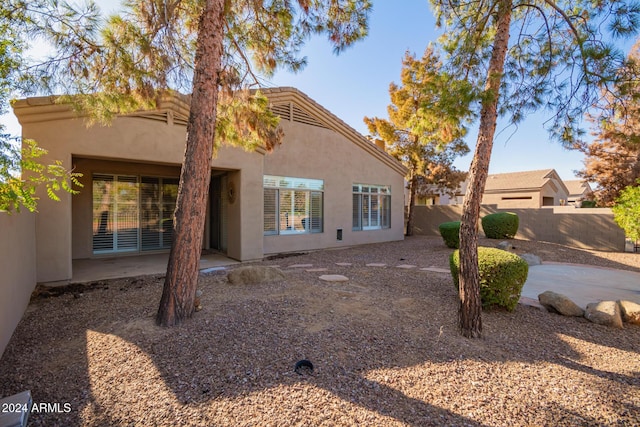 rear view of property featuring a patio area