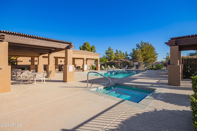 view of swimming pool with a community hot tub and a patio