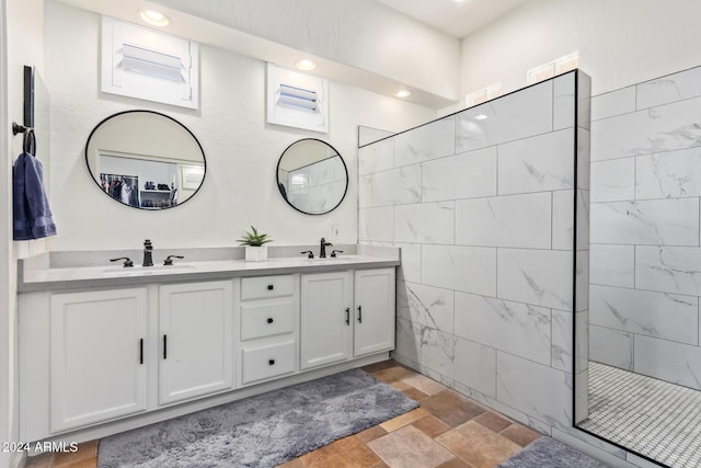 bathroom with vanity and tiled shower