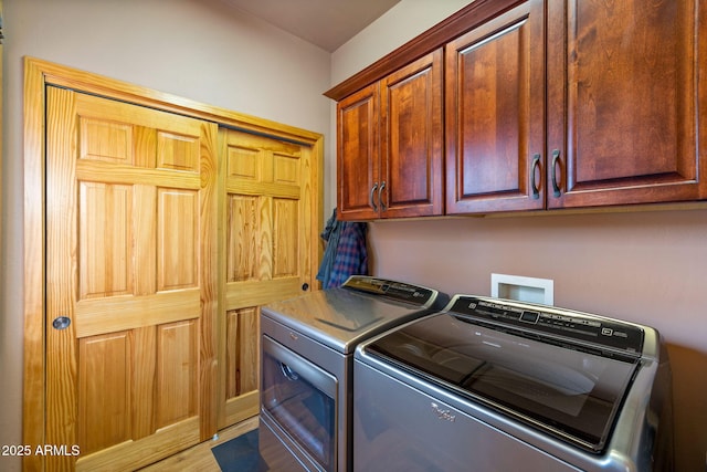 washroom featuring cabinets and washing machine and dryer