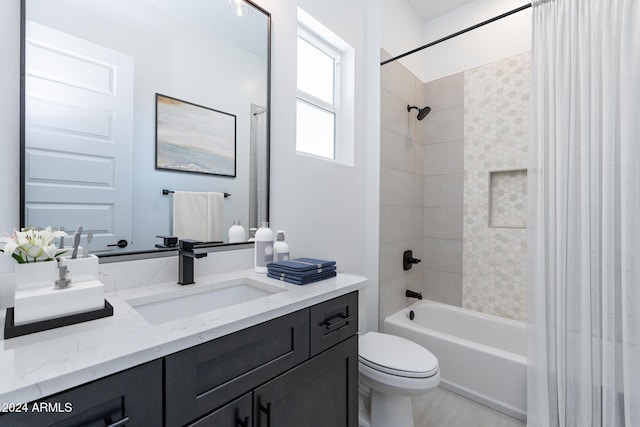 full bathroom with tiled shower / bath combo, toilet, and vanity