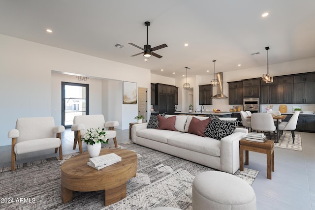 living room with ceiling fan and sink