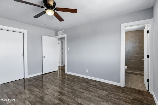 unfurnished bedroom with baseboards, visible vents, wood finished floors, and a closet