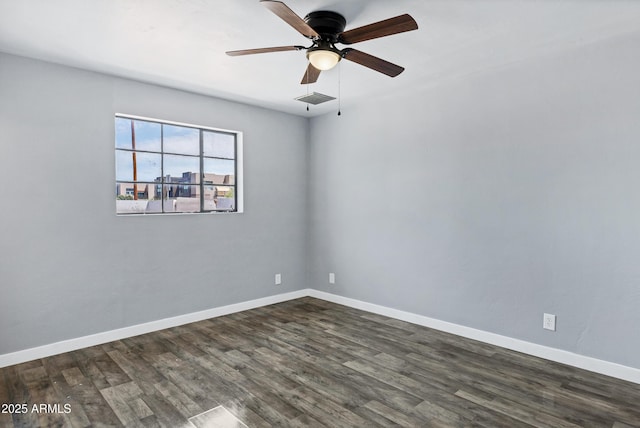 unfurnished room with baseboards, a ceiling fan, dark wood-type flooring, and visible vents