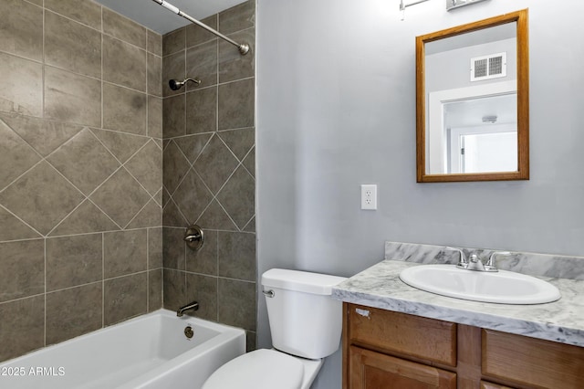 bathroom with vanity, washtub / shower combination, toilet, and visible vents