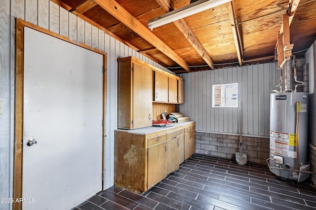below grade area featuring gas water heater and dark wood-style floors