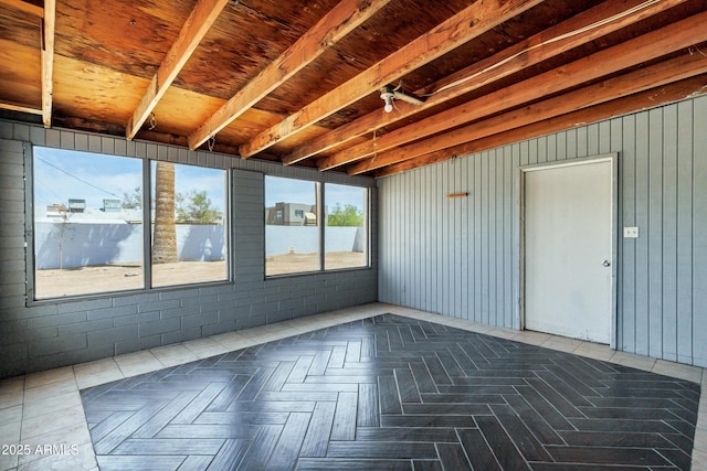 unfurnished sunroom featuring a water view